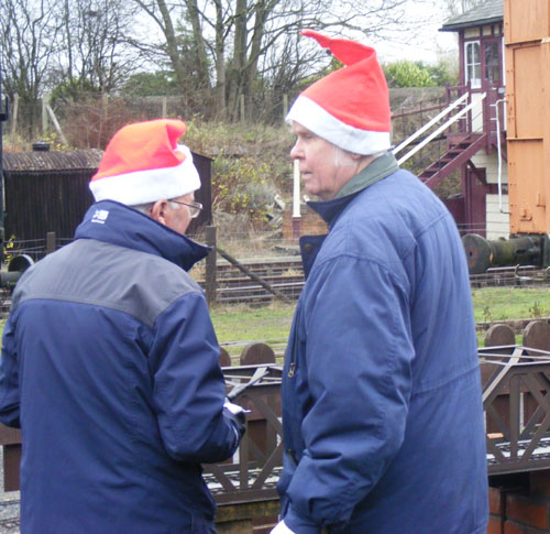 Two Santas in deep conversation